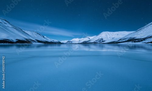 a frozen lake surrounded by snow-covered mountains