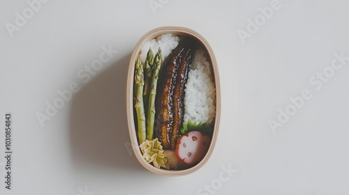 Elegant Bento Presentation: A minimalist bento—grilled eel (unagi), blanched asparagus, and kinpira gobo (burdock root). 