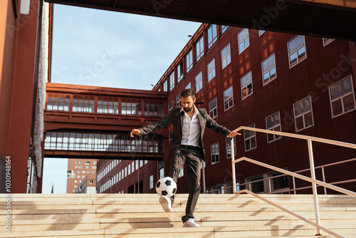 Businessman playing with a soccer ball and making freestyle tricks