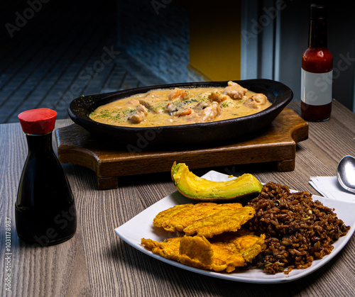 Amarillo a la Monseñor: A delectable dish of yellow fish, perfectly cooked and served with a rich, traditional sauce. Accompanying this, a beautifully presented plate of fried rice, crispy plantain sl