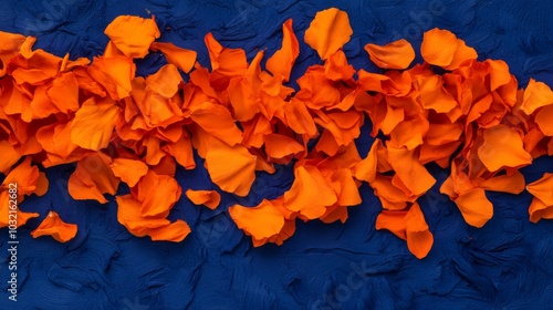 cascading orange marigold petals create an abstract, flame-like pattern against a deep indigo backdrop, evoking the warmth and vibrancy of may's flowering abundance