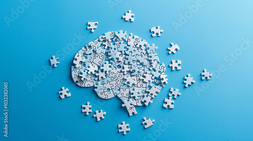 puzzle pieces arranged in the shape of human brain against a plain blue background, concept of brain storming critical thinking mental health 