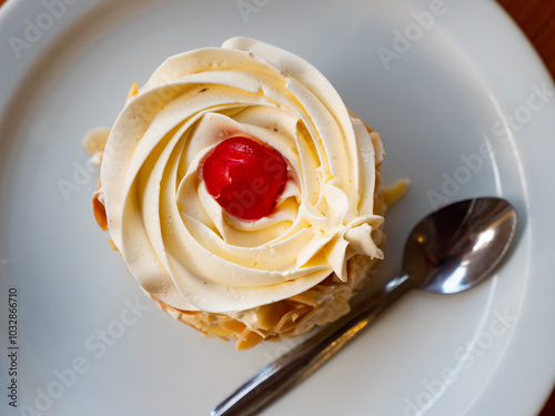 Appetizing cake Sara's Sweets, made with buttery cream on top and crushed almonds on the side