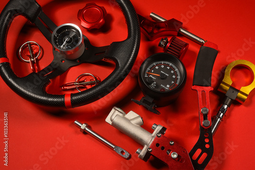 Sport car tuning equipment and spare parts on red top view background with copy space. Motorsport concept background.