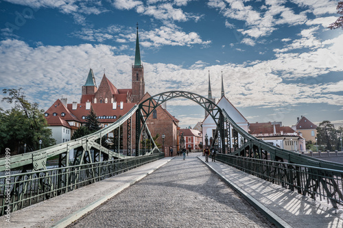 Historic Tumski Bridge Leading to a Picturesque Cathedral in Wroc