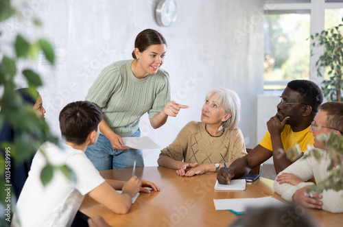 Young female manager holds round table meetings for employees of different nationalities