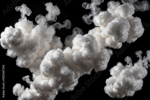 Flying clumps of cotton wool isolated on a black background