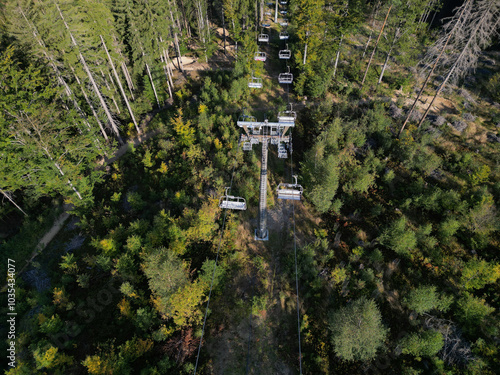 The chair lift in the mountains transports skiers to the slopes in the winter and cyclists riding trill tracks on mountain bikes in the summer.