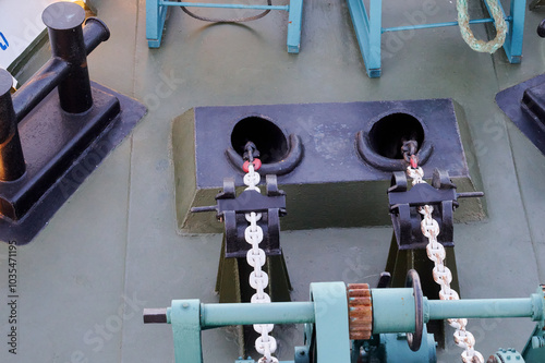 A reel with a wound steel cable on the stern of a motor ship against the background of seething water. The ship's movement.