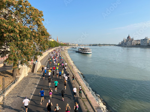 rear view crowd people running marathon race along embankment in Budapest