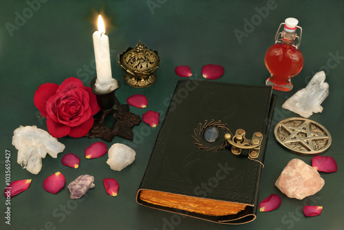 Witchcraft love potion concept with rose flower, petals, magical equipment with book of spells, crystals, heart shaped bottle for concoction. Ancient preparation occult wicca tradition.