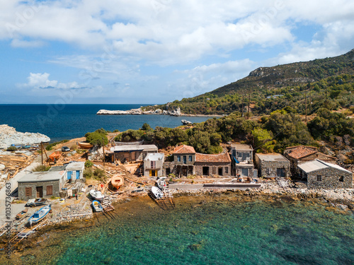 Old dock with boats in Ormos Agios Isidoros on Greek Samos island, summer day, drone view.