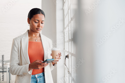 Business, woman and coffee with phone in office for work break, text message and checking notifications. Professional, employee and smartphone by window with social media scroll or online browsing