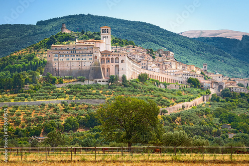 Historic town of Assisi on mountainside at Umbria in Italy with cathedral and castle