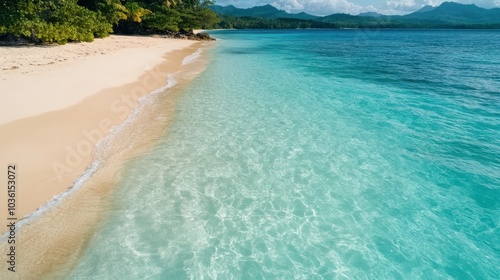 Crystal clear turquoise water meets a pristine sandy shore, surrounded by lush greenery, radiating peace and inviting tranquility amidst unspoiled paradise.