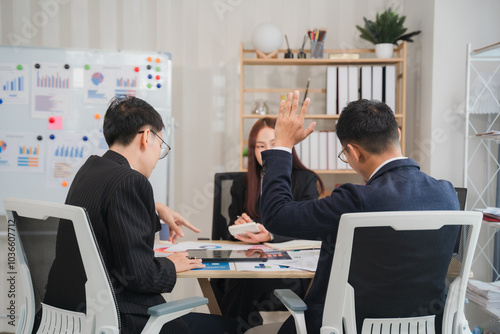 Strategic Brainstorm: A dynamic team engages in a lively brainstorming session, ideas flowing freely around a conference table. The image captures the energy and collaboration of a modern workplace.