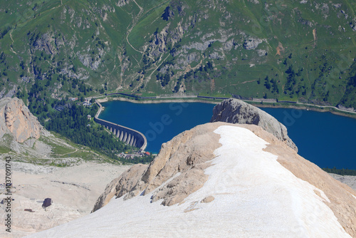 Fedaia Lake and glacier of Marmolada Mountain that is shrinking every year due to global warming