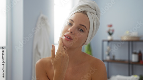 Young woman with towel on her head in spa salon beauty center room wellness indoors