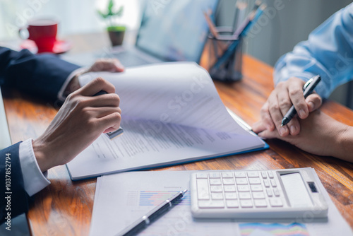 Businesswoman reviewed mortgage document and contract with their client, ensuring loan and credit details were clear, while discussing estate insurance and other finance aspects. finance, credit, pay.