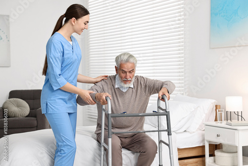 Nurse helping senior man with walking frame in clinic