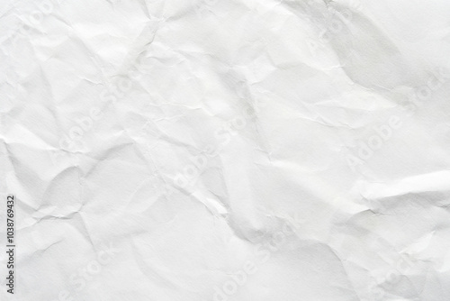 Crumpled white paper texture with natural creases and subtle shadows for backgrounds and design projects.