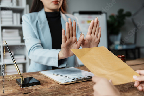 Businesswoman is refusing to receive money in brown envelope, corruption concept