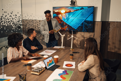 Diverse expert with solar panels at office having briefing at boardroom