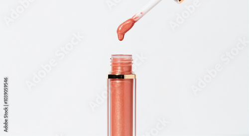 Lip gloss with applicator showcasing shiny makeup texture and creamy finish