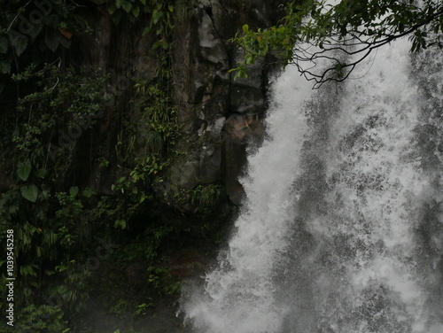 close up of third carbet waterfall with powerful stream cascading and rocks, in basse terre. Guadeloupe nature destination