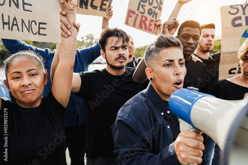 Multigenerational people protest against climate change - Crowd doing demonstration for stopping pollution - Green and environment concept - Focus on woman with megaphone