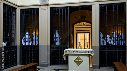 Palermo, Italy, September 03, 2017, Monastery of Santa Caterina, cloistered grates of the nuns for participation in mass with an open missal in the foreground