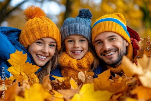 Family playing in a pile of leaves, enjoying the simple pleasures of fall on a bright November afternoon