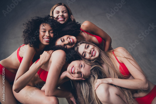 No retouch photo of stunning cheerful fashion models community together on gray concrete wall background in studio