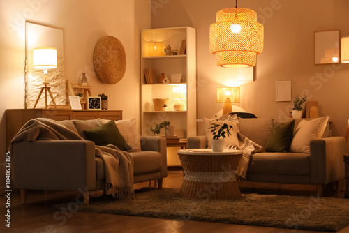 Interior of living room with sofas, coffee table and glowing lamps