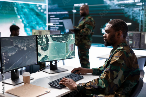 Military personnel in high tech command post work on data integration, processing real time surveillance. Maintaining security protocols to support strategic secret service operations.