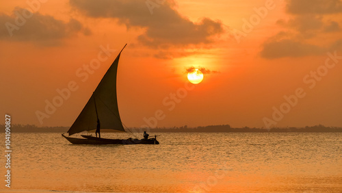 Sunset on a Zanzibar beach with a traditional dhow