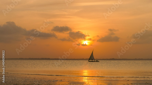 Sunset on a Zanzibar beach with a traditional dhow