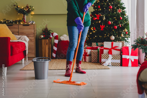 Photo of woman cleaning home house wash floor with mop indoors new year xmas holidays