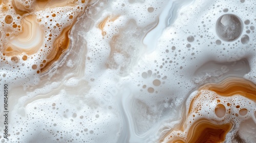 This abstract image features a close-up of foamy textures swirling in shades of orange and white, reminiscent of ethereal landscapes or gaseous clouds.