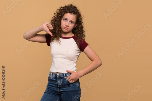 Young girl showing thumbs-down gesture