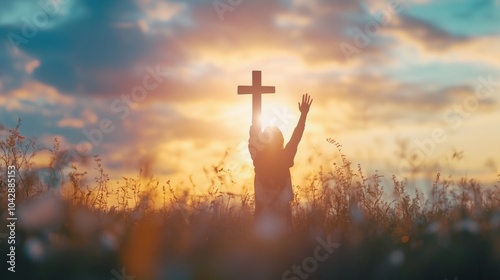 Worship God concept: Silhouette christian people hand rising over blurred cross on spiritual light background