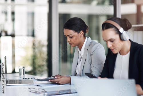 Women, headphones and employees working with laptop, tablet and confidence in office. Small business, financial advisor and corporate entrepreneur with documents for affirmative action law firm