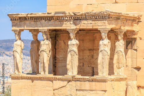 A group of statues of women are displayed on a wall, Acropolis in Athens