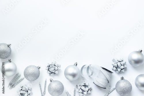 Frame of silver Christmas and New Year decorations on white background. Top view