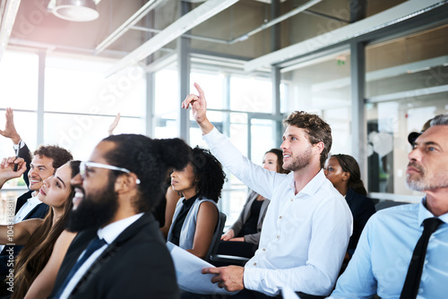 Hand raised, conference and business people in office for meeting, seminar or discussion. Question, event and team of financial advisors in audience at finance training for investment planning.