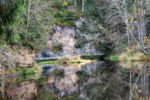 sandstone outcrops on the bank of Brasla river, colorful trees in autumn, bright colors, Latvia