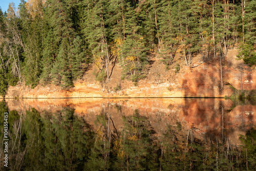 sandstone outcrops on the bank of Brasla river, colorful trees in autumn, bright colors, Latvia