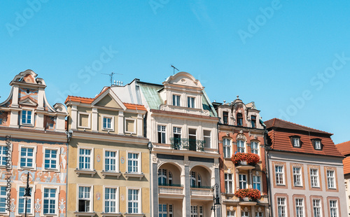 Colorful Historic Buildings and Houses on Stary Rynek Square in Poznań, Poland, with a Blue Sky and Mural Art