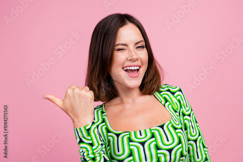 Close up photo of lovely cheerful woman wear green clothes recommend novelty empty space isolated on pink color background