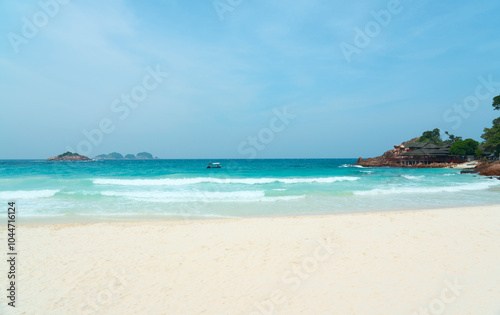 Turquoise water lapping on the white sand of a tropical beach